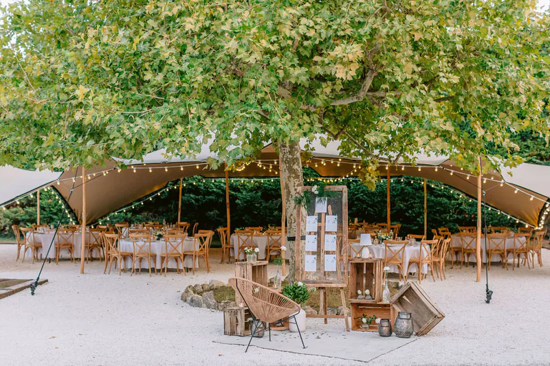 Tables dressées sous la tente et le grand platane, à la Bastide des Barattes