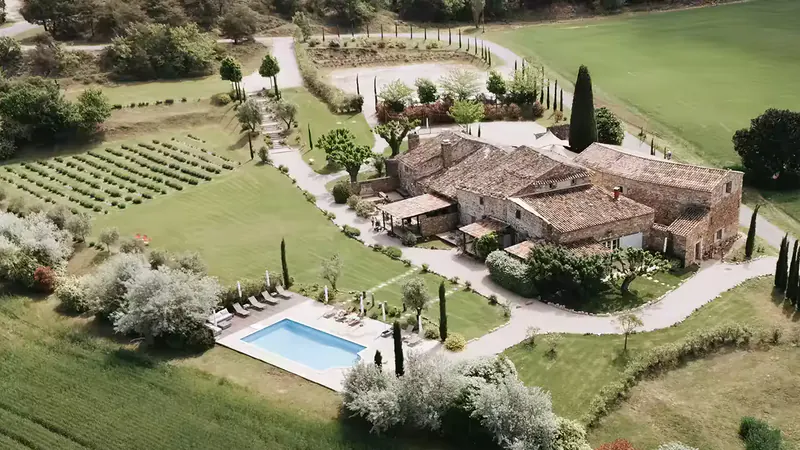 Aerial view of the stone hamlet of Le Clos du Tuilier, its pool and the lavender rows surrounding it